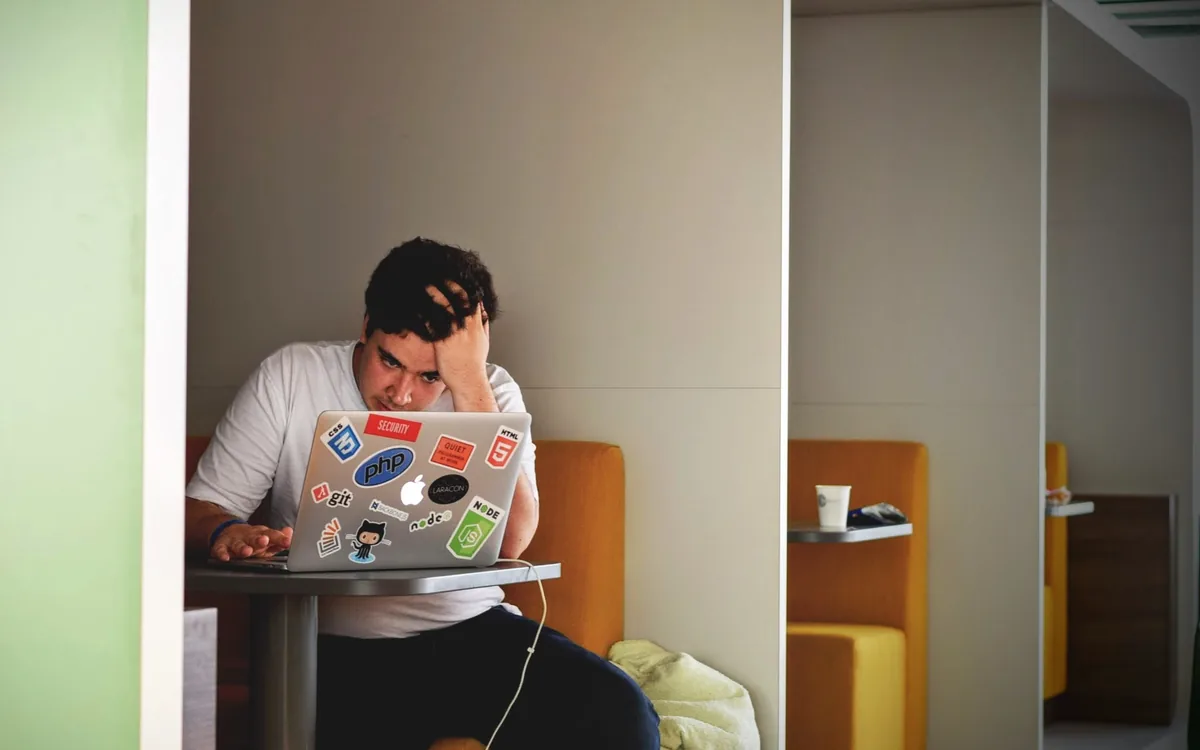 Person relaxed at a laptop with a clean, simple workspace